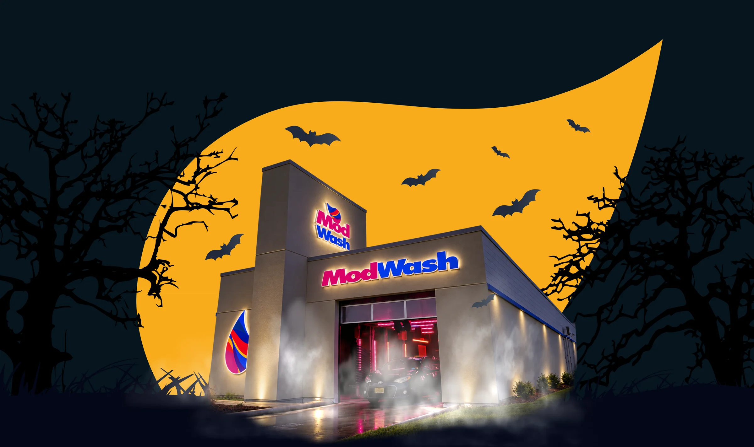 A ModWash tunnel glowing with spooky lights under a harvest moon